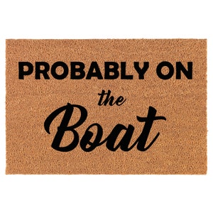 May include: A brown coir doormat with the text "PROBABLY ON the Boat" in black.