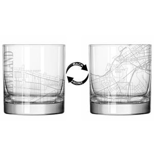 May include: Two clear, lowball glasses with a detailed map of Cleveland, Ohio, etched on the surface. One glass shows the front and the other the back, with the word "Cleveland" vertically on one side. The glasses are ideal for serving cocktails.