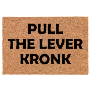 May include: A brown coir doormat with the text "PULL THE LEVER KRONK" in black.