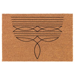 May include: A rectangular doormat with a brown coir surface. The mat features a black stitched design of horizontal lines, curved shapes, and a central geometric pattern. The design is centered on the mat.