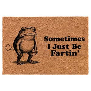 May include: A rectangular doormat with a brown background and a black illustration of a frog. The frog is standing and has a cloud of gas coming from its rear. The text reads "Sometimes I Just Be Fartin'".