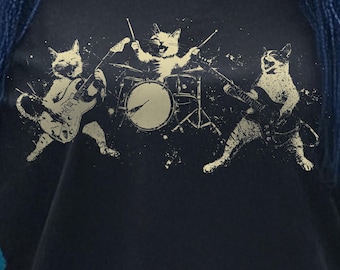 May include: A black t-shirt with a graphic print of three cats playing music. The cat on the left is playing a guitar, the cat in the middle is playing drums, and the cat on the right is playing a bass guitar.