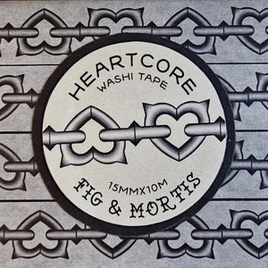 May include: A roll of Heartcore washi tape by Fig & Mortis featuring a repeating black and white pattern of heart-shaped chain links. The circular label displays the text Heartcore Washi Tape and Fig & Mortis with dimensions of 15mm x 10m.