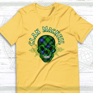 May include: Yellow t-shirt with a green, blue, and black skull graphic. The skull is wearing a tartan pattern and the text "Clan MacNeil" is written around the skull.