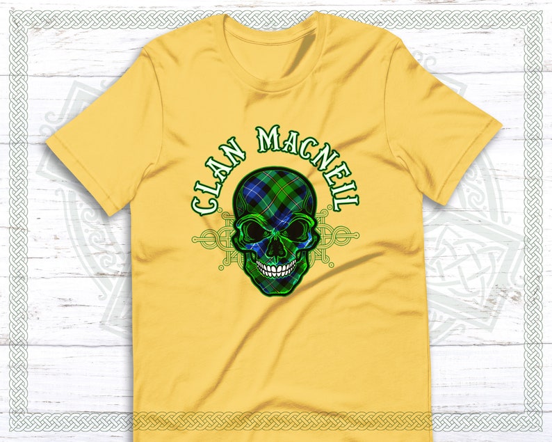 May include: Yellow t-shirt with a green, blue, and black skull graphic. The skull is wearing a tartan pattern and the text "Clan MacNeil" is written around the skull.