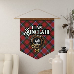 May include: A red, green and blue tartan wall banner with the text "Clan Sinclair" in a gold script font. The banner features a crest with a white rooster and the text "Commit thy work to God".