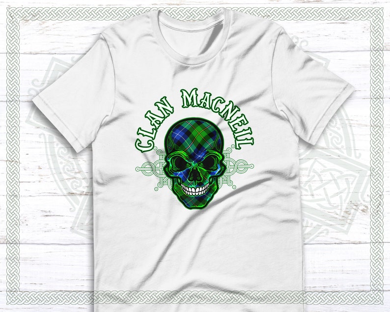 May include: White t-shirt with a green, blue, and white plaid skull design. The text "Clan MacNeil" is written around the skull.