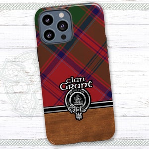 May include: A red, green, and blue plaid phone case with a silver clan crest and the text "Clan Grant Stand Fast".