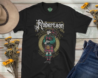 May include: Black t-shirt with a graphic of a skeleton playing bagpipes. The graphic includes the text "Clan Robertson" and a Celtic knot design.