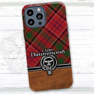 May include: A red, green, and black plaid phone case with a silver clan crest and the text "Clan Drummond Eling Warily".