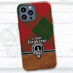 May include: A red and green plaid phone case with a brown wood-grain bottom. The case features a crest with the text "Clan Erskine" and the motto "Je Pense Plus".