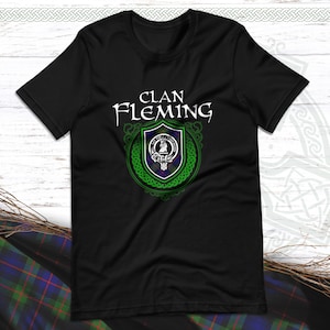 May include: Black t-shirt featuring a green and blue clan crest with the text "Clan Fleming" in white.