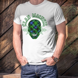 May include: White t-shirt with a green, blue, and white skull graphic and the text "Clan MacNeil" printed on the front.
