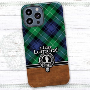 May include: A green, blue, and white plaid phone case with a silver clan crest and the text "Clan Lamont" in black. The crest features a hand with the text "NE PIRCA NE SPERNA" around it.
