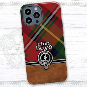 May include: A red, green, and black plaid phone case with a wood-grain design on the bottom. The case features a crest with the text "Clan Boyd" and "Confido" in gold lettering.