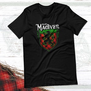 May include: Black t-shirt with a green and red tartan crest featuring a lion and the text "Clan MacIver".
