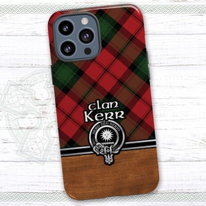 May include: A red, green, and black plaid phone case with a silver clan crest and the text "Clan Kerr" in black. The crest features a sun with rays and the text "Sero Sed Serio".