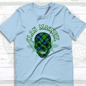 May include: Light blue t-shirt with a green, blue, and black skull design. The skull is wearing a tartan pattern and the text "CLAN MACNEIL" is written around the skull.
