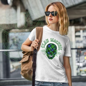 May include: White t-shirt with a green, blue, and white plaid skull graphic and the text "Clan MacNeil".