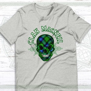 May include: Gray t-shirt with a green, blue, and black skull design. The skull is wearing a tartan pattern and the text "Clan MacNeil" is written around the skull.