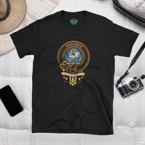May include: Black t-shirt with a gold and blue crest featuring a white rooster and the text "Vigilance Laing".