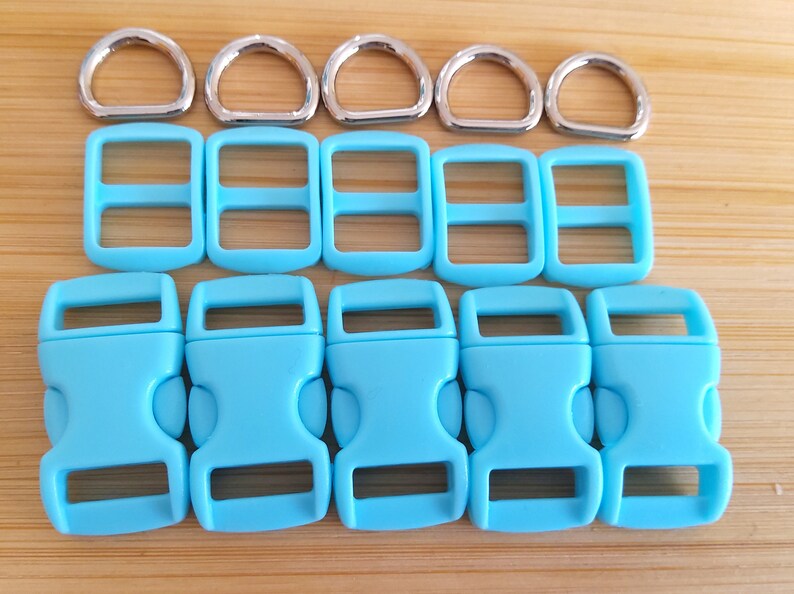 May include: A set of 6 light blue plastic side release buckles and 6 silver metal D-rings. The buckles are 1 inch wide and the D-rings are 1 inch in diameter.