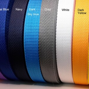 May include: A selection of 11 different coloured webbing straps. The colours are red, purple, royal blue, navy, dark sky blue, grey, white, dark yellow, light yellow, and burgundy.