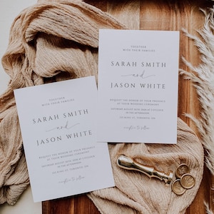 May include: Two white wedding invitations with black text, featuring the names "Sarah Smith" and "Jason White." A gold wax seal and stamp are next to the invitations. The invitations are on a beige fabric and a wooden tray.