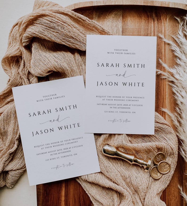 May include: Two white wedding invitations with black text, featuring the names "Sarah Smith" and "Jason White." A gold wax seal and stamp are next to the invitations. The invitations are on a beige fabric and a wooden tray.