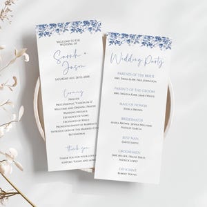 May include: Two wedding program cards with blue floral accents. The cards feature the names "Sarah + Jason" and "Wedding Party", along with ceremony details and guest lists. The text is in a delicate, handwritten style.
