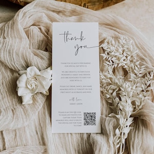May include: A white thank you card with black text. The card says "Thank you" in a script font and includes a message thanking guests for sharing their special day. The card also includes a QR code and the text "Please scan this QR code to share any photos you capture today. Your memories will help us relive this special day for years to come!"