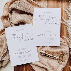 May include: Two white wedding rehearsal dinner invitations with black text, reading "The Night Before" and listing the date, time, and location. A gold wax seal stamp and wax seals are on a beige cloth.