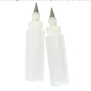 May include: Two clear plastic squeeze bottles with white tops and metal tips. The bottles are labeled with the text "Sweet Sugarbelle". These bottles are designed for precise decorating and are ideal for icing and other culinary applications.