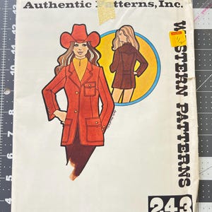 May include: Vintage sewing pattern titled "Authentic Patterns, Inc." featuring illustrations of Western-style clothing. The cover art showcases a woman in a red jacket and cowboy hat, with a second illustration in a blue circle. The number "243" is prominently displayed.