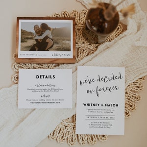 May include: Wedding invitation suite with a white background and black text. The top card says "we've decided on forever" with the couple's names "Whitney & Mason" below. The bottom card has the wedding date, time, and location. The card also includes the text "Together with their families invite you to celebrate their love and marriage".