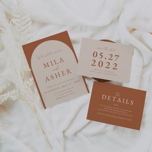 May include: A wedding invitation suite with a modern design. The main invitation features a brown and beige color scheme with the names Mila and Asher and the date Saturday, May 27, 2022. The save the date card is beige with brown text and the date 05.27.2022. The details card is brown with white text and the website www.yourweddingwebsite.com.
