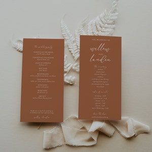 May include: Two terracotta-coloured cards with white text. The left card lists the wedding party members and their roles. The right card lists the wedding ceremony order and the order of events. The text on the right card reads "The Wedding of Willow and Landon".