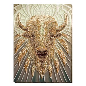 May include: A beaded artwork depicting a white buffalo with a geometric pattern on its face. The buffalo is surrounded by a radiating pattern of feathers, all made of beads.