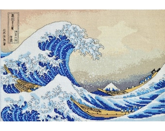 May include: A cross-stitch rendition of "The Great Wave off Kanagawa" by Katsushika Hokusai. The iconic blue wave is depicted with white foam and two boats with people in them. The background is a light beige with a hint of blue and a mountain in the distance.