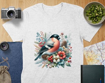 May include: A white t-shirt with a colorful illustration of a bird perched on a branch with red berries and flowers. The bird has a red breast and black and white wings.