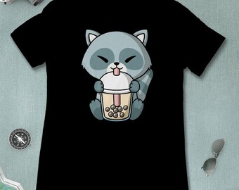 May include: Black t-shirt with a cartoon raccoon wearing a blue and gray shirt holding a cup of boba tea.