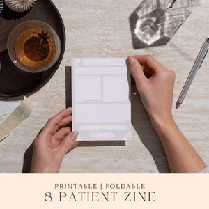 Peut inclure: Une personne tient un zine pliable et imprimable blanc pour 8 patients. Le zine a un design gris clair avec des sections pour les notes. Un stylo argenté repose sur la surface. Le texte "PRINTABLE | FOLDABLE" et "8 PATIENT ZINE" est en bas.