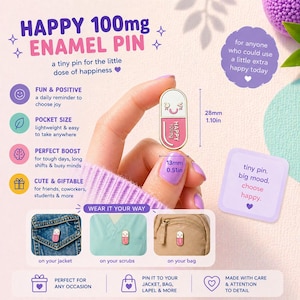 May include: A pink and white enamel pin in the shape of a capsule, with the text "HAPPY 100mg". The pin is 2.8cm long and 1.3cm wide. The image also shows the pin attached to a jacket, scrubs, and a bag.