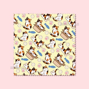 May include: A square fabric swatch with a pale yellow background featuring a repeating pattern of calico cats in various poses, including sitting in brown cardboard boxes, blue fish, white daisies, and pink paw prints with the text MOCHIVILLE.