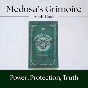 Medusa's grimoire book laying on white background. Cover is green with serpent symbolism.