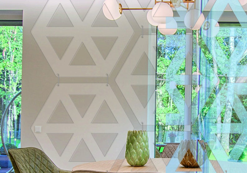 May include: A modern dining room with a large window overlooking a lush green forest. The room features a geometric patterned wall, a wooden table, and two green chairs. A decorative green artichoke-shaped vase sits on the table.