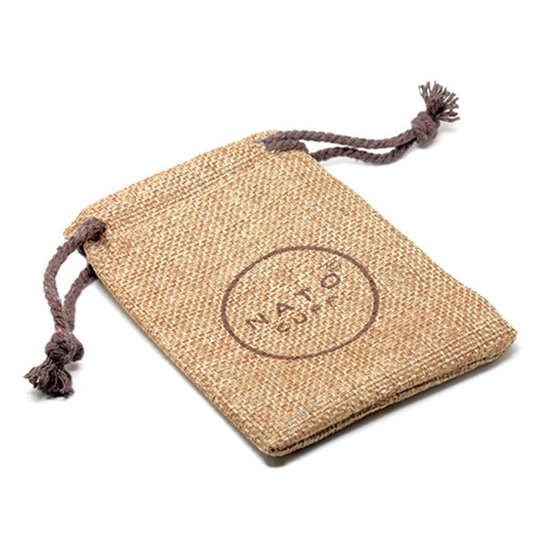 May include: A small, brown burlap drawstring bag with a brown logo that says "NATOG COFFE" printed on the front.