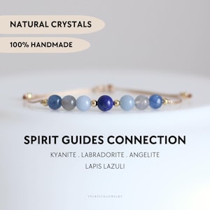 May include: A beaded bracelet featuring natural kyanite, labradorite, angelite, and lapis lazuli stones interspersed with small gold-toned metal beads on a thin cord. Text reads: NATURAL CRYSTALS, 100% HANDMADE, SPIRIT GUIDES CONNECTION, KYANITE, LABRADORITE, ANGELITE, LAPIS LAZULI, YPCRYSTALJEWELRY.