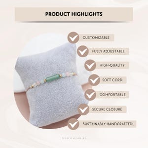 May include: A gold bracelet with a green rectangular bead and pink and clear round beads. The bracelet is displayed on a gray pillow. Text in the image reads "Product Highlights" and lists features such as "Customizable" and "Fully Adjustable."