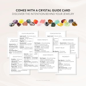 May include: A collection of multicolored polished crystals arranged in a row above several white information cards. The text reads COMES WITH A CRYSTAL GUIDE CARD DISCOVER THE INTENTION BEHIND YOUR JEWELRY and lists various crystal names and meanings.